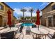 Community pool with tables, chairs, and umbrellas at 7820 E Baseline Rd # 103, Mesa, AZ 85209