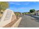 Gated entrance to Village at South Mountain community, featuring stonework and landscaping at 7917 S 32Nd Ter, Phoenix, AZ 85042