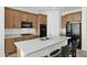 Modern kitchen with light wood cabinets and island seating at 7917 S 32Nd Ter, Phoenix, AZ 85042