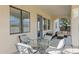 Relaxing covered patio with seating and glass-top table at 7917 S 32Nd Ter, Phoenix, AZ 85042