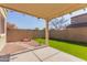 Covered patio, artificial turf, and fire pit at 8827 W Dahlia Dr, Peoria, AZ 85381