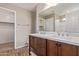 Double vanity bathroom with dark wood cabinets and a large mirror at 8827 W Dahlia Dr, Peoria, AZ 85381