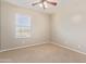 Simple bedroom with a single window and ceiling fan at 8827 W Dahlia Dr, Peoria, AZ 85381