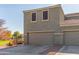 Two-story home exterior with a two-car garage and landscaped yard at 8827 W Dahlia Dr, Peoria, AZ 85381