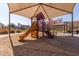 Community playground with covered play structure and sand area at 8827 W Dahlia Dr, Peoria, AZ 85381