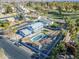 Aerial view of a house, pool, and surrounding landscape at 925 W Fairway Dr, Mesa, AZ 85201