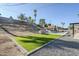 Landscaped backyard with artificial turf and a rock border at 925 W Fairway Dr, Mesa, AZ 85201