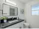 Modern bathroom with dark countertop, updated vanity, and stylish mirror at 925 W Fairway Dr, Mesa, AZ 85201