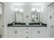 Double vanity bathroom with dark countertop and modern lighting at 925 W Fairway Dr, Mesa, AZ 85201