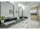 Modern bathroom with double vanity and black countertop at 925 W Fairway Dr, Mesa, AZ 85201