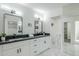 Modern bathroom with double vanity, marble floors, and walk-in shower at 925 W Fairway Dr, Mesa, AZ 85201