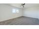 Well-lit bedroom with ceiling fan and carpet at 925 W Fairway Dr, Mesa, AZ 85201