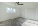 Bright bedroom with ceiling fan, carpet, and large closet at 925 W Fairway Dr, Mesa, AZ 85201