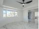 Bright bedroom with bay window, marble floors, and ceiling fan at 925 W Fairway Dr, Mesa, AZ 85201