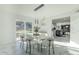 Bright dining room with glass table, white chairs, and marble floors at 925 W Fairway Dr, Mesa, AZ 85201