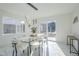 Modern dining room with glass table and white chairs, marble floors at 925 W Fairway Dr, Mesa, AZ 85201