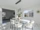 Modern dining room with glass table and white chairs, marble floors at 925 W Fairway Dr, Mesa, AZ 85201