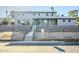 Two-story house with gray siding, stone wall, and a wood-framed entryway at 925 W Fairway Dr, Mesa, AZ 85201