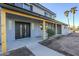 Modern front entry with wood beams, black door, and sleek lighting at 925 W Fairway Dr, Mesa, AZ 85201