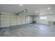 Spacious two-car garage with painted floor and extra storage at 925 W Fairway Dr, Mesa, AZ 85201