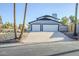 Two-car garage with white doors and a sloped driveway at 925 W Fairway Dr, Mesa, AZ 85201