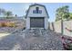 Detached garage with barn-style doors and a small wooden ramp at 925 W Fairway Dr, Mesa, AZ 85201