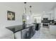 Modern kitchen with dark cabinetry, marble flooring, and stainless steel appliances at 925 W Fairway Dr, Mesa, AZ 85201