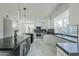 Modern kitchen with large island, white cabinets, and marble floors at 925 W Fairway Dr, Mesa, AZ 85201