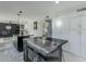 Modern kitchen with large island, marble flooring and white cabinetry at 925 W Fairway Dr, Mesa, AZ 85201