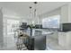 Modern kitchen with large island, white cabinets, and marble floors at 925 W Fairway Dr, Mesa, AZ 85201