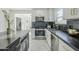 Modern white kitchen with dark countertops and gold accents at 925 W Fairway Dr, Mesa, AZ 85201