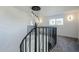 Open landing with a modern spiral staircase and crystal chandelier at 925 W Fairway Dr, Mesa, AZ 85201