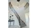 Elegant curved staircase with wrought iron railings and a modern chandelier at 925 W Fairway Dr, Mesa, AZ 85201