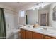 Inviting bathroom includes a large mirror, double sinks, combination tub and shower, and great lighting at 9325 E Fairfield St, Mesa, AZ 85207