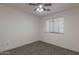 A cozy bedroom with neutral colors, soft carpet, and plenty of natural light from the window at 9325 E Fairfield St, Mesa, AZ 85207