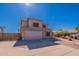 Two-story home featuring a driveway and an attached two-car garage at 9325 E Fairfield St, Mesa, AZ 85207