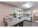 Well-lit kitchen features white cabinets, quartz counters, and stainless steel appliances at 9325 E Fairfield St, Mesa, AZ 85207