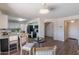 Bright living room features views to the kitchen, access to a staircase, and hardwood flooring at 9325 E Fairfield St, Mesa, AZ 85207