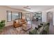 Open-concept living room with hardwood floors, modern furniture, and a view of the pool outside at 9325 E Fairfield St, Mesa, AZ 85207