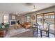 Cozy living room with hardwood floors, a fireplace, and a sliding door to the backyard pool at 9325 E Fairfield St, Mesa, AZ 85207