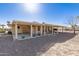 Spacious backyard with covered patio, gravel landscaping, and mature trees at 9826 W Emberwood Dr, Sun City, AZ 85351