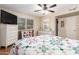 Well-lit bedroom with hardwood floors and ceiling fan at 9826 W Emberwood Dr, Sun City, AZ 85351