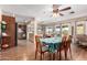 Open dining area with hardwood floors and view to kitchen at 9826 W Emberwood Dr, Sun City, AZ 85351