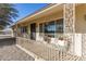 Covered porch with decorative railing and potted plants at 9826 W Emberwood Dr, Sun City, AZ 85351