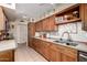 Updated kitchen featuring wood cabinets, granite countertops, and tile backsplash at 9826 W Emberwood Dr, Sun City, AZ 85351