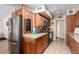 Modern kitchen with stainless steel appliances and wood cabinetry at 9826 W Emberwood Dr, Sun City, AZ 85351