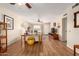 Open living area with hardwood floors and a view into dining area at 9826 W Emberwood Dr, Sun City, AZ 85351