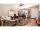 Living room with hardwood floors, large window, and comfy seating at 9826 W Emberwood Dr, Sun City, AZ 85351