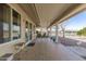 Covered patio with tile flooring, outdoor seating, and a view of the backyard at 9826 W Emberwood Dr, Sun City, AZ 85351