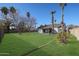 Large backyard with grassy lawn, mature trees, and a covered patio at 1025 E Kerry Ln, Phoenix, AZ 85024